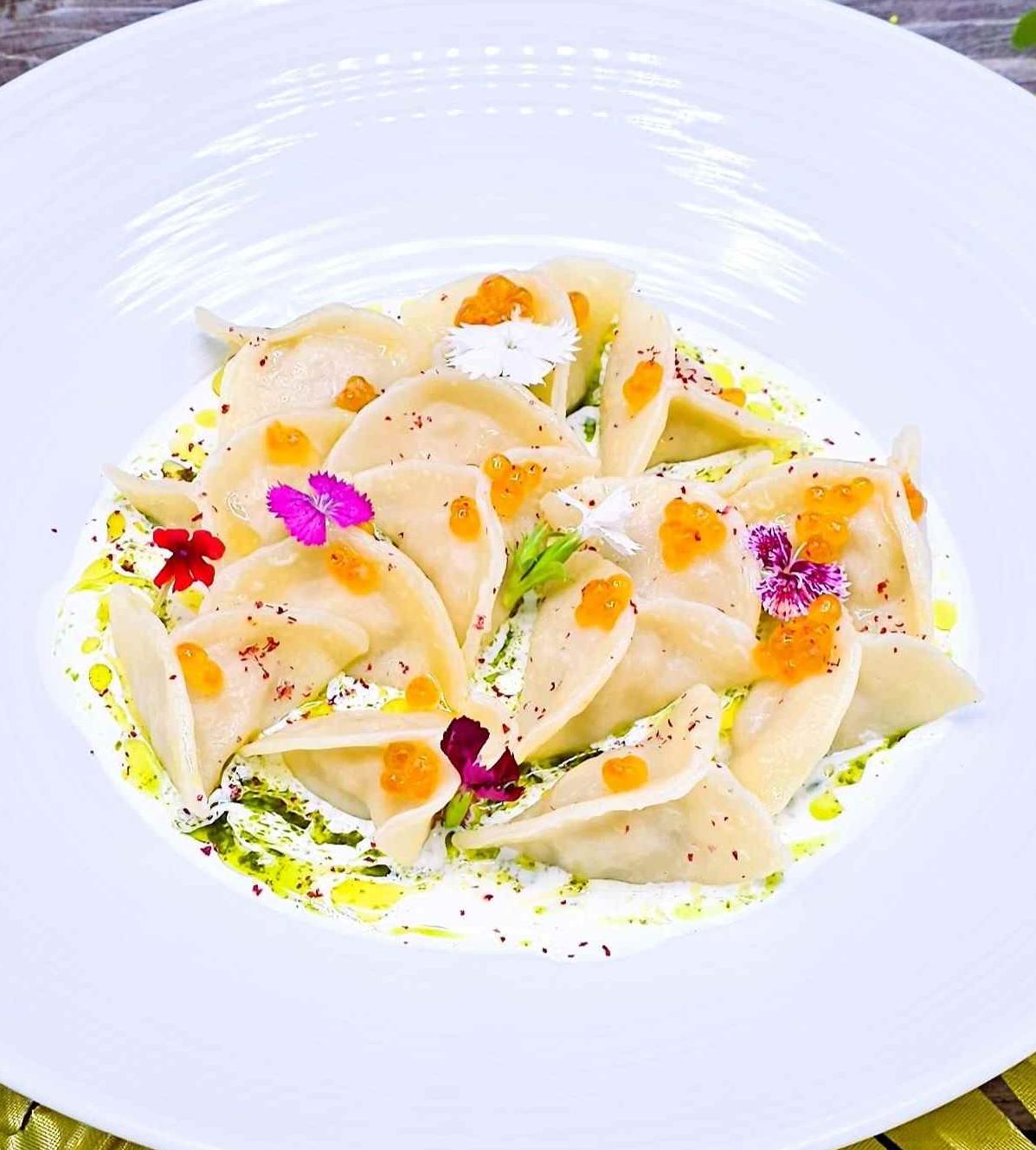 Dumplings with wild salmon and red caviar sauce