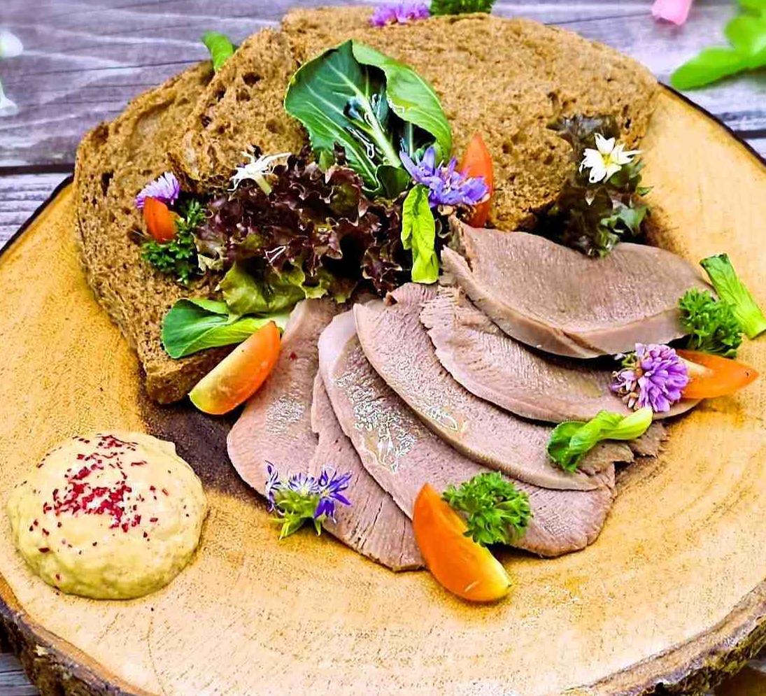 Tongue with homemade horseradish, toast, herbs and cherry tomatoes
