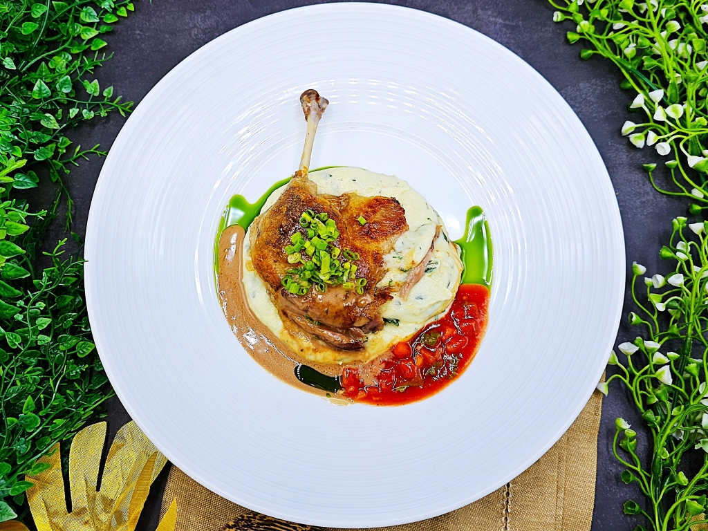 Duck leg confit with mashed potatoes and herbs