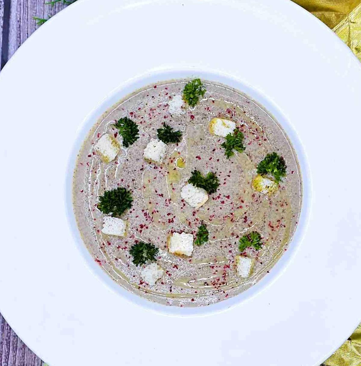 Cream of young mushroom and black truffle soup with croutons