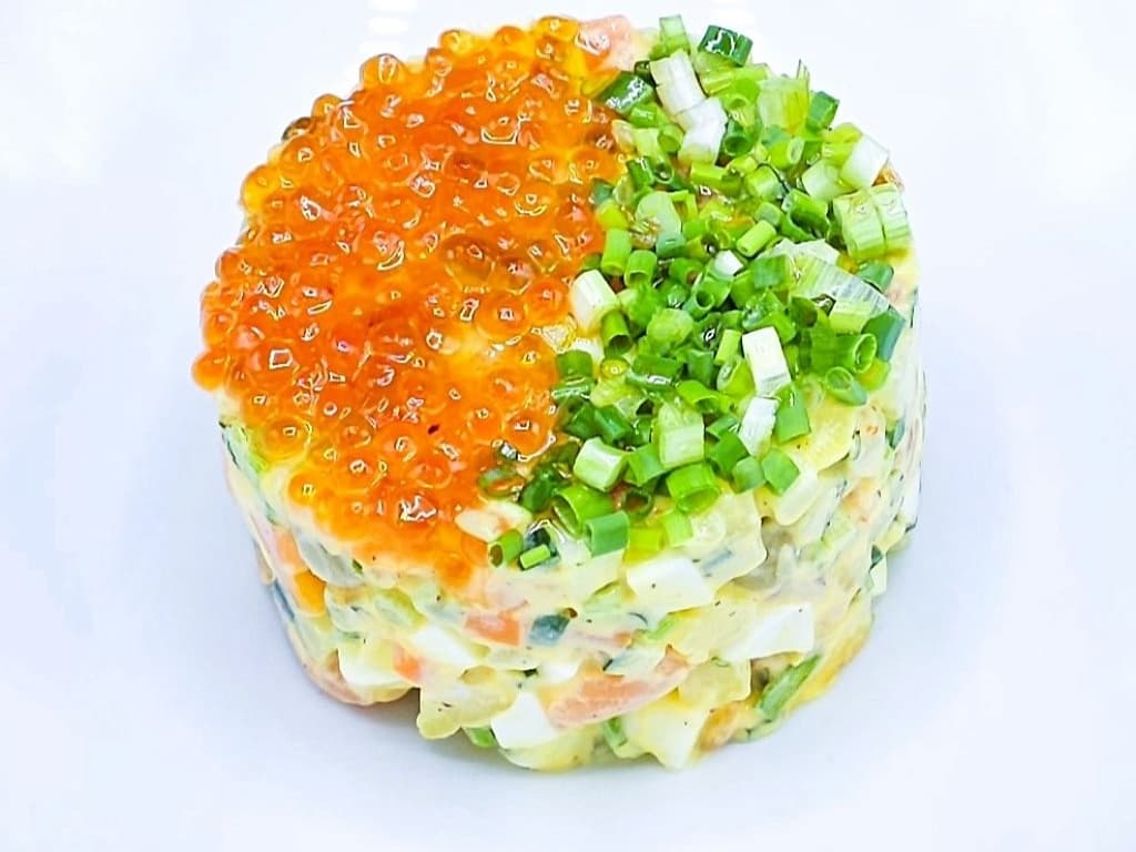 Olivier salad with lightly salted salmon and red caviar