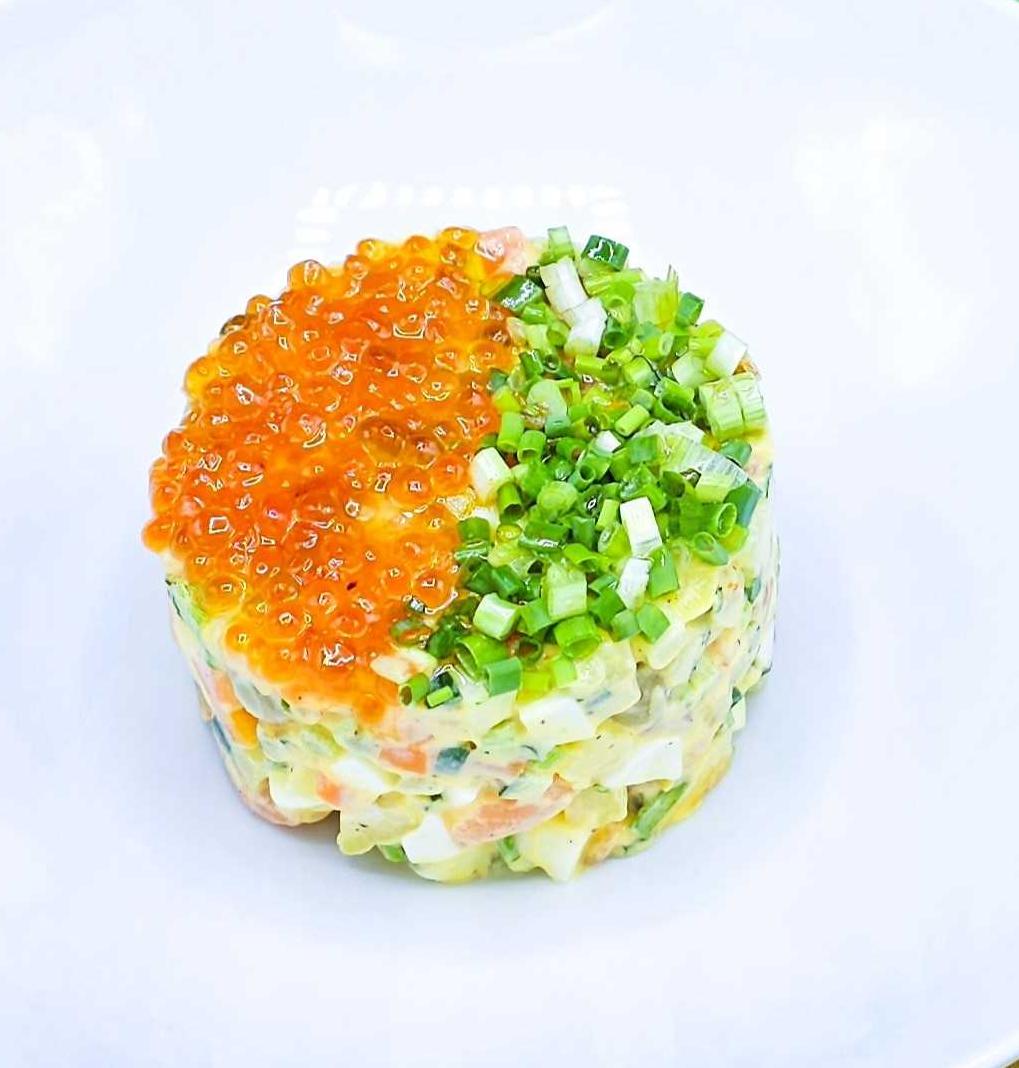 Olivier salad with lightly salted salmon and red caviar
