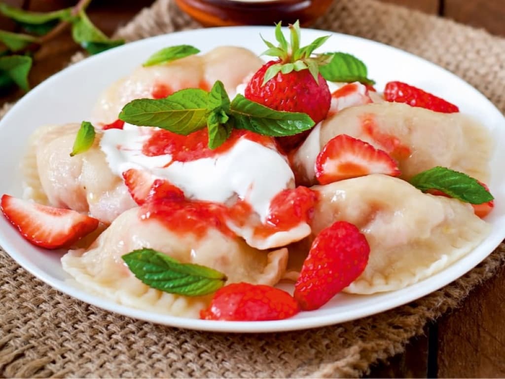 Dumplings with strawberries and raspberry caramel