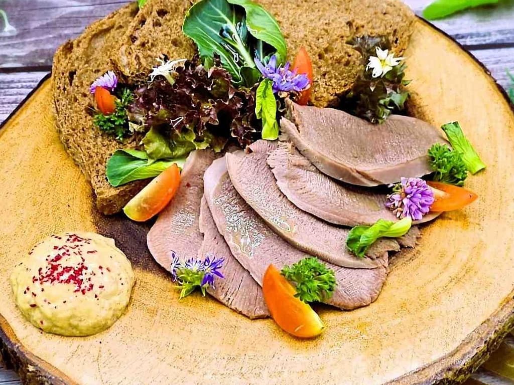 Tongue with homemade horseradish, toast, herbs and cherry tomatoes