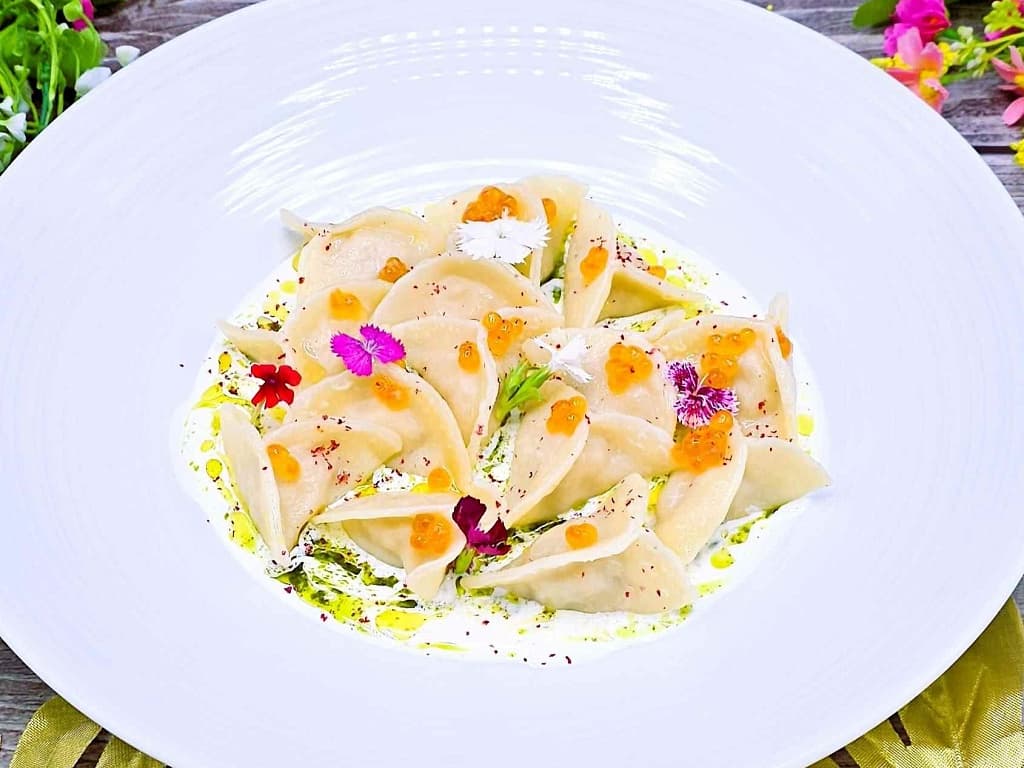 Dumplings with wild salmon and red caviar sauce